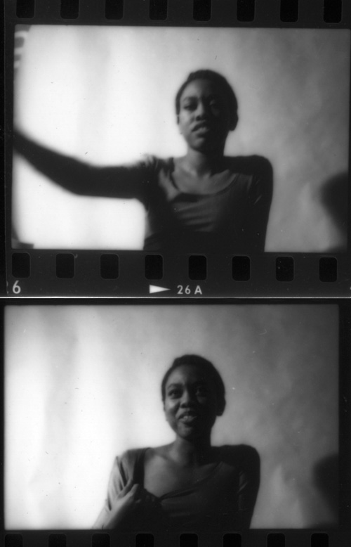 Two blurry black-and-white film frames with sprocket holes: a young woman in a t-shirt gesturing, then smiling shyly