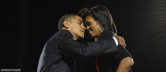 Barack and Michelle Obama embracing forehead-to-forehead on election night, black stage behind — AFP/Getty frame