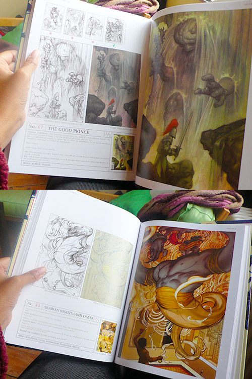 Hands holding open James Jean's Fables covers book: 'No. 67 The Good Prince' with knight and giants, and 'No. 43 Arabian Nights (and Days)' djinn spread