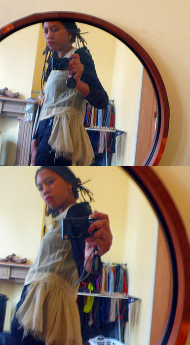 Two round-mirror selfies trying on a sheer cream babydoll top with ragged hem over dark jeans, clothes rack behind