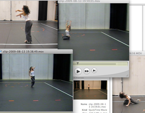 QuickTime windows of dance-studio clips: a dancer improvising alone on a black floor marked with tape, seen from the corner — Drama Princess motion reference QuickTime windows of dance-studio clips: a dancer improvising alone on a black floor marked with tape, seen from the corner — Drama Princess motion reference