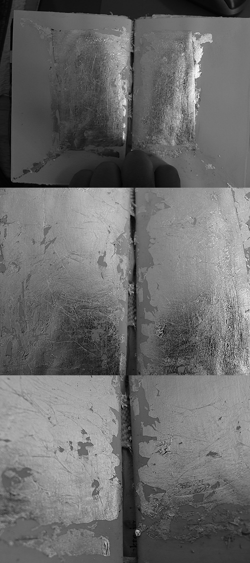 Three views of a small book silvered edge to edge: metal leaf cracking and peeling across the gutter of its open pages