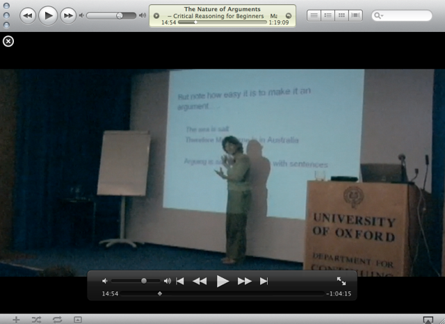 Video lecture paused at 14:54 — 'The Nature of Arguments', Critical Reasoning for Beginners, a lecturer beside a slide at the University of Oxford podium