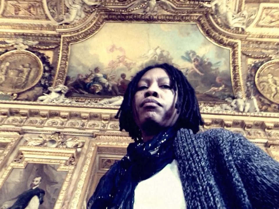New Year selfie from below in the Louvre's gilded galleries, painted ceiling of gods and putti overhead, chin high