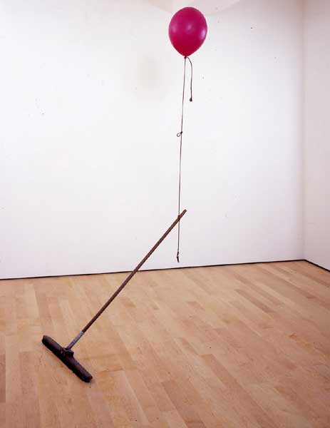 Urs Fischer's A Place Called Novosibirsk: a push broom standing in an empty gallery, held upright only by a red balloon tied to its handle