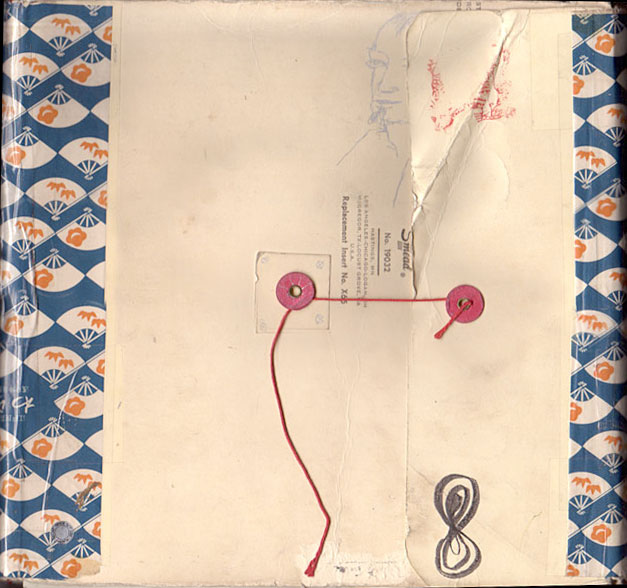 Cover of sketchbook 27: a cream string-tie envelope with red button closures, bordered in blue-and-orange Japanese fan paper, a faint face sketched at top
