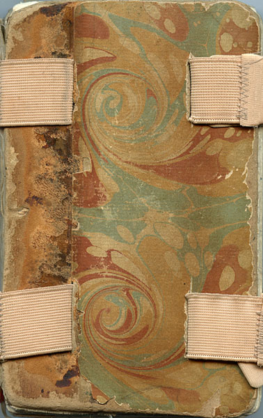 Cover of sketchbook 28: swirling marbled paper in sage, rust and cream, held shut by four pale elastic bands