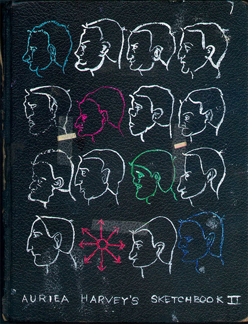 Cover of sketchbook 2: rows of white profile heads drawn on black leather, a few picked out in blue, pink and green, with a chaos star — 'Auriea Harvey's Sketchbook II'