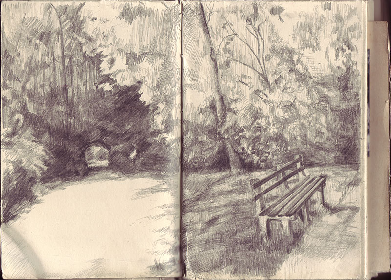 Sketchbook 38 spread in ballpoint: a park path curving under trees toward a small stone bridge, an empty bench in dappled shade