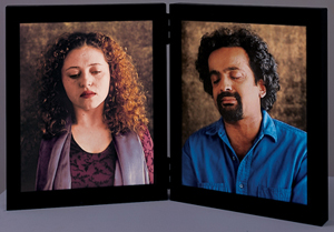 Bill Viola's Dolorosa: a hinged diptych of two video portraits in the manner of devotional panels — a curly-haired woman and a bearded man, both weeping with closed eyes