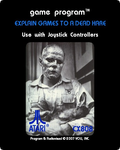 Mock Atari cartridge label 'Explain Games to a Dead Hare': Joseph Beuys with gold-leafed head cradling the dead hare, 'Use with Joystick Controllers', © 2007 YOU, INC.