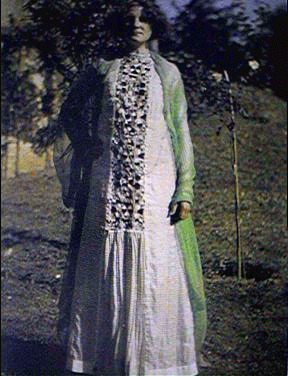 Early color photograph of Emilie Flöge standing in a garden wearing a flowing white reform dress with appliquéd panel, designed with Gustav Klimt Early color photograph of Emilie Flöge standing in a garden wearing a flowing white reform dress with appliquéd panel, designed with Gustav Klimt