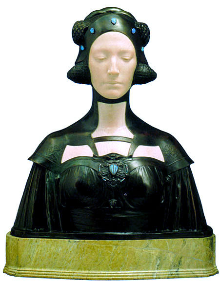 George Frampton's Lamia: a polychrome bust with a pale ivory face, eyes downcast, encased in a dark bronze headdress and gown set with opals George Frampton's Lamia: a polychrome bust with a pale ivory face, eyes downcast, encased in a dark bronze headdress and gown set with opals