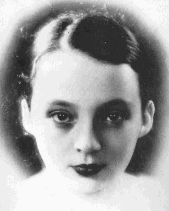 Soft-focus black-and-white studio portrait of a girl with dark marcel-waved hair and dark painted lips, gazing steadily at the camera Soft-focus black-and-white studio portrait of a girl with dark marcel-waved hair and dark painted lips, gazing steadily at the camera