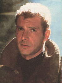 Harrison Ford as Rick Deckard in Blade Runner, looking up warily in his rough brown coat, hair damp