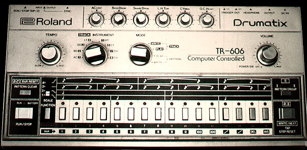 A Roland TR-606 Drumatix drum machine: silver face with accent and drum knobs above a row of sixteen grey step buttons