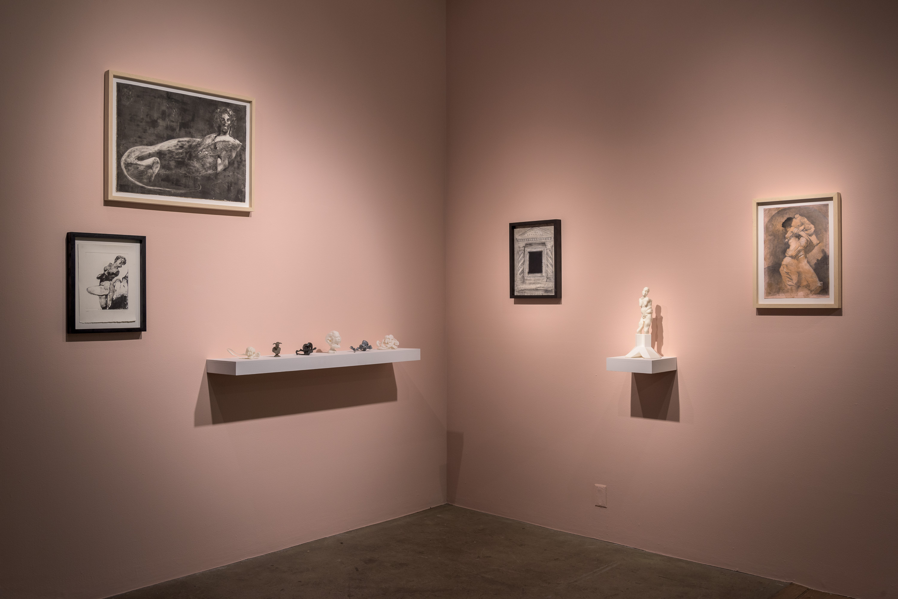 Year Zero at bitforms, the rose-pink room: framed monotypes and drawings, a shelf of small dark maquettes, and a white figure on its bracket