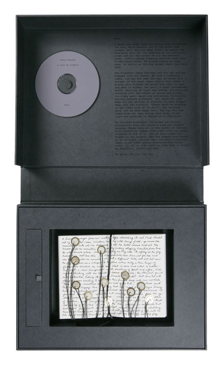 Robin Minard's à voir, en silence: a black boxed edition holding a grey CD in the lid and a handwritten score sprouting wiry stems tipped with small piezo discs