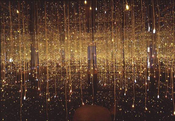 Yayoi Kusama's Fireflies on the Water: an infinity mirror room strung with countless golden points of light trailing into black water