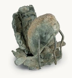 Small verdigris bronze: a rough crouched form, part shell and part gilled fungus, raised on thin wire legs over a bed of cast leaves