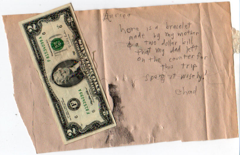 Child's pencil note on torn pink paper with a two-dollar bill pinned under it: here is a bracelet made by my mother and a two dollar bill my dad left — spend it wisely, Chad